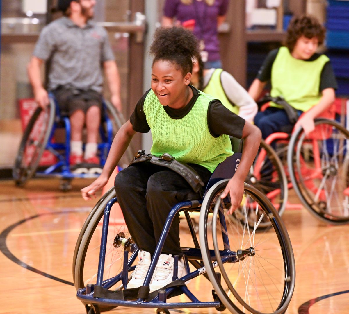 Fifth-grader Ashanti Bradley furiously wheels to the far end of the gymnasium Tuesday at Westview Elementary in Spokane, where the Parasport Spokane group let elementary kids try out their wheelchairs, commonly used for basketball, so that the kids could learn about disabled athletes and how they compete.  (Jesse Tinsley/THE SPOKESMAN-REVIEW)