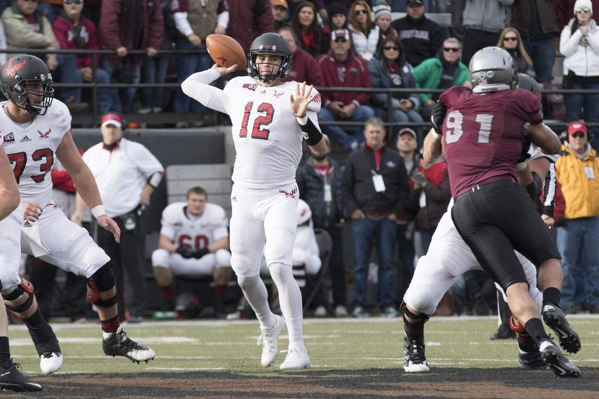 Eastern Washington quarterback Reilly Hennessey (12) throws a pass against Montana in the first half of an NCAA college football game Saturday, Nov. 14, 2015, in Missoula, Mont. (Patrick Record / AP)