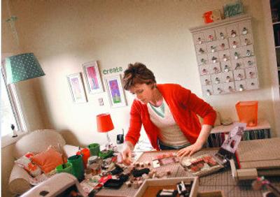 
Stacy Julian works on a scrapbook in the studio of her Liberty Lake home. Julian is a leader in the scrapbooking industry. 
 (Photos by Brian Plonka/ / The Spokesman-Review)
