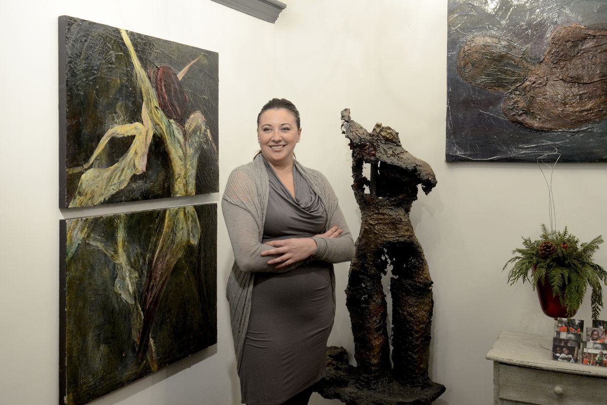 Jennifer Gray stands with her artwork at Josefine’s, her hair salon in downtown Spokane on Dec. 13. The painting at left is acrylic on wooden panels; the figure is papier-mâché over chicken wire. (JESSE TINSLEY PHOTOS)