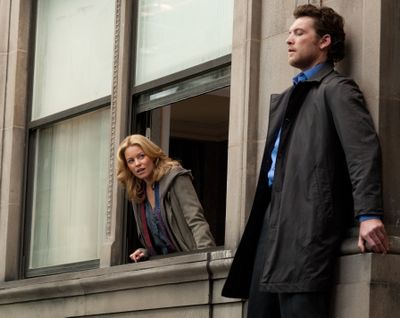 Elizabeth Banks, left, and Sam Worthington are shown in a scene from “Man on a Ledge.”