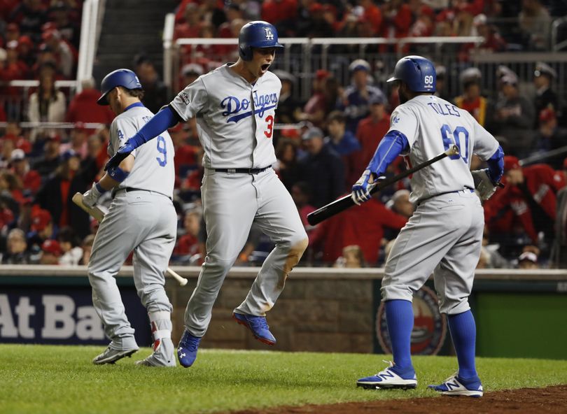 Los Angeles Dodgers Joc Pederson (31) celebrates his solo home run with teammates Yasmani Grandal (9) and Andrew Toles (60) during the seventh inning Thursday. (Pablo Martinez Monsivais / Associated Press)