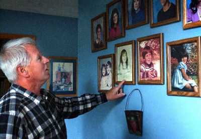 
Ron Connell points out the four bottom photos of his children. The pictures  survived 