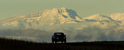 
The early morning sun hits fresh snow on Steamboat Mountain in the Rocky Mountain Front Range as a pickup travels south on Interstate 15 near Ulm, Mont., on Wednesday. A storm dumped large amounts of heavy, wet snow across parts of Montana on Tuesday evening. 
 (Associated Press / The Spokesman-Review)