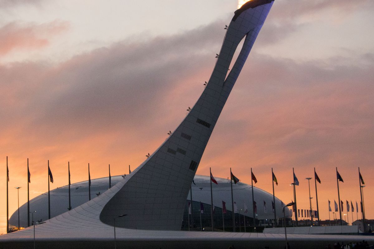 The sun sets behind the Olympic Flame in Sochi, Russia February 11, 2014. BSU at the Games/ Taylor Irby