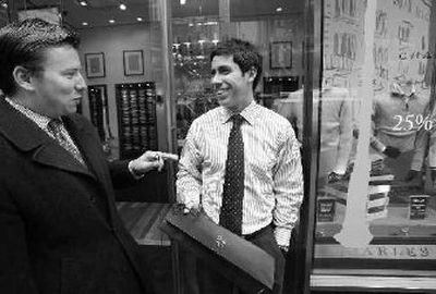 
Tad Knier, right, talks with colleague Ryan Tirre after purchasing a necktie at Charles Tyrwhitt, a London-based clothing store, in New York's Times Square. 
 (Associated Press / The Spokesman-Review)