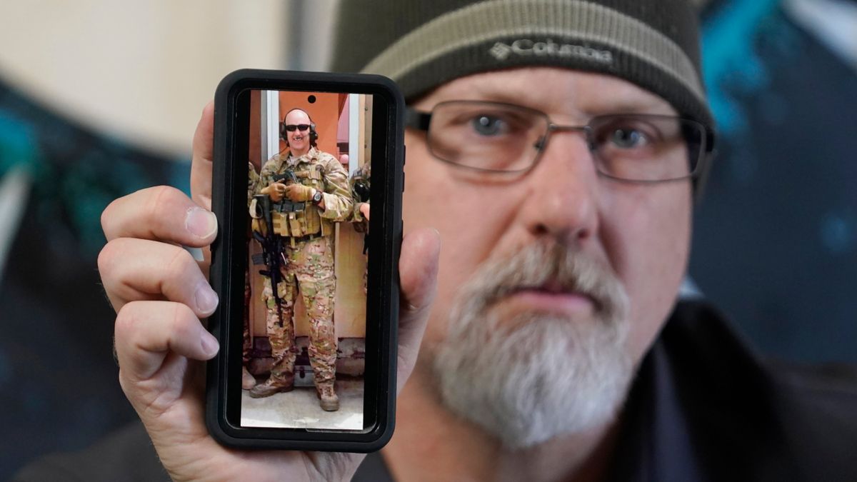 Matthew Butler, who spent 27 years in the Army, holds a 2014 photograph of himself during his last deployment in Kabul Afghanistan, on Wednesday, March 30, 2022, in Sandy, Utah. Butler is now one of the military veterans in several U.S. states who are helping convince conservative lawmakers to take cautious steps toward allowing the therapeutic use of hallucinogenic mushrooms and other psychedelic drugs. The therapeutic used of so-called magic mushrooms and other psychedelic drugs is making inroads in several U.S. states, including some with conservative leaders, as new research points to their therapeutic value and military veterans who have used them to treat post-traumatic stress disorder become advocates.  (Rick Bowmer)