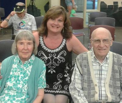Cindy is shown with Dean and Betty Ratzman, who were sitting in the front row during her reading of 