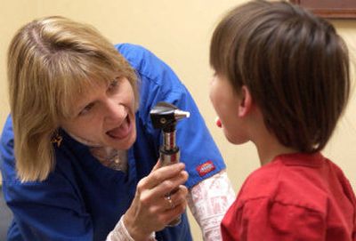 
Dr. Susan Ashley shows Hunter Genne, 4, how to say 