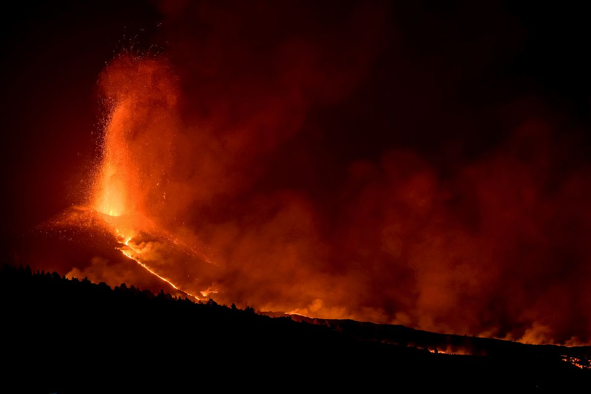 Lava flows from a volcano on the Canary island of La Palma, Spain on Saturday Oct. 2, 2021. An erupting volcano on a Spanish island off northwest Africa has blown open another fissure on its hillside. Authorities were watching Friday to see whether lava from the new fissure would join the main flow that has reached the sea. The new fissure is the third to crack open since the Cumbre Vieja crater erupted on La Palma island Sept. 19.  (Daniel Roca)