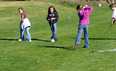 
Dalton Elementary fifth-graders Kaylee Hushman, left, and Jessica Mather, center, participated in the school's life sports class at Ponderosa Springs Golf Course in Coeur d'Alene.
 (Linda Ball/For Handle Extra / The Spokesman-Review)