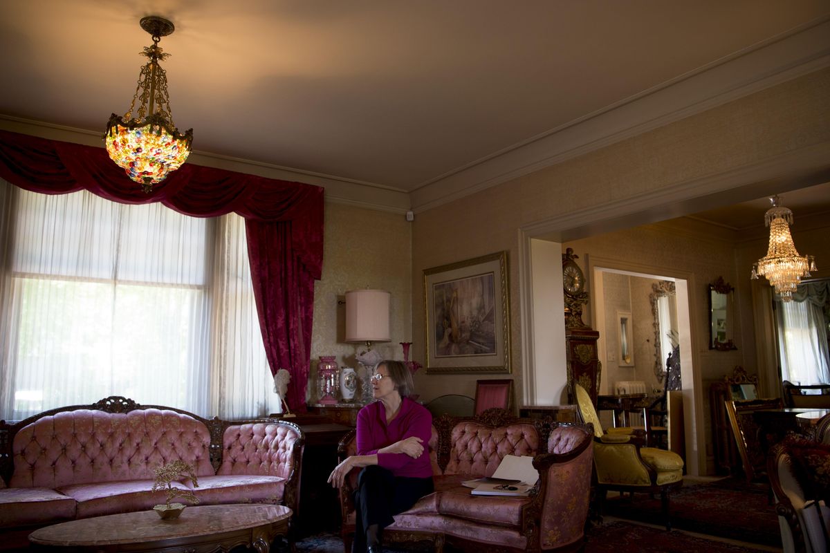 The MAC’s Marsha Rooney sits in the living room of Myrtle Woldson’s grand home on Monday. (Tyler Tjomsland / The Spokesman-Review)