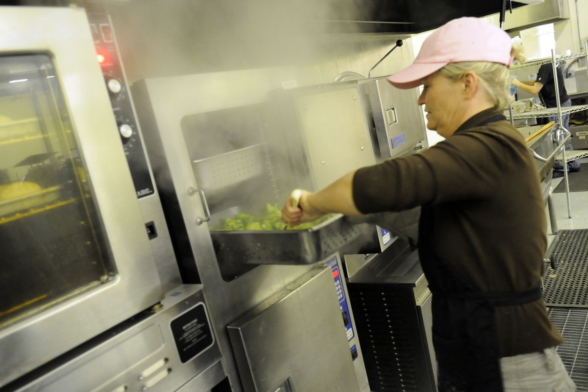 Chef Jerri Horton stirs broccoli for the Meals on Wheels luncheon Monday. She was getting ready Monday to cook more than 200 pounds of turkey for the Thanksgiving meal, which was Wednesday. (PHOTOS BY J. BART RAYNIAK)