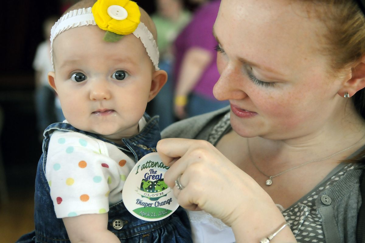 Claire Rush affixes an “I attended the Great Cloth Diaper Change” sticker onto her daughter, Daisy, 5 months old, after the pair participated Saturday in an attempt to set a Guinness World Record at the Woman’s Club of Spokane. (Dan Pelle)