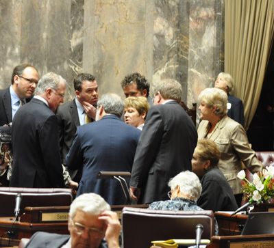 OLYMPIA -- Senate Democrats talk strategy on the floor of the Senate after Republicans took control of the process in a fight over the budget on March 2. (Jim Camden)