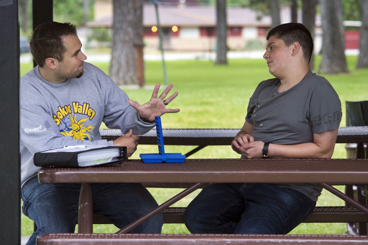 Spokane Valley Parks and Recreation intern Brendon Rannou, left, gestures after winning a game of Connect Four against Jordan Minnihan, 14, on Tuesday at Terrace View Park. Rannow was mistaken and was defeated by his opponent during the activities program. (Dan Pelle)