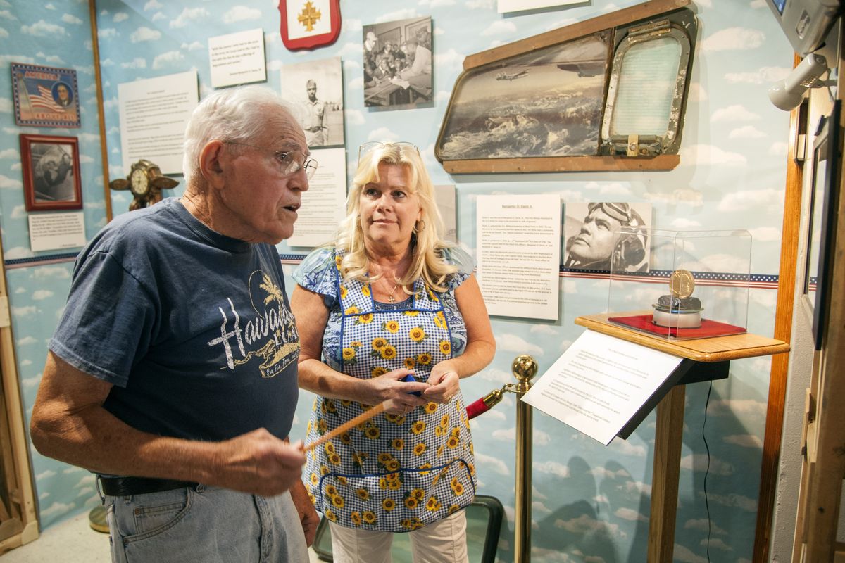 Volunteer Bill Zimmer and museum director Jayne Singleton install the newest exhibit at the Spokane Valley Heritage Museum, “The Colors of Patriotism.” (Colin Mulvany)