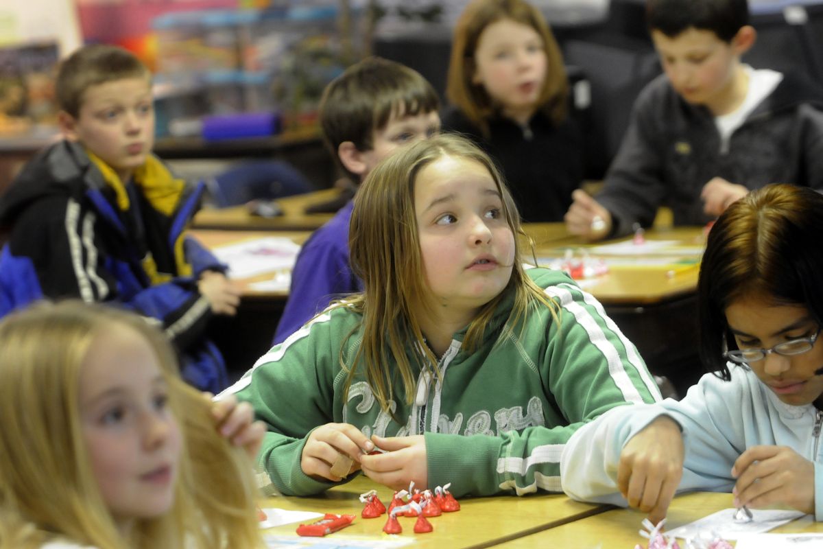 bartr@spokesman.com Progress Elementary School fourth-grader Corie Kraus listen for bingo numbers while playing with chocolate candy during Math Games Night after school, Feb. 17. More than  140 children stayed after school to play games designed to reinforce the concepts they learn during the day from the new math curriculum that was adopted this year. (J. BART RAYNIAK)