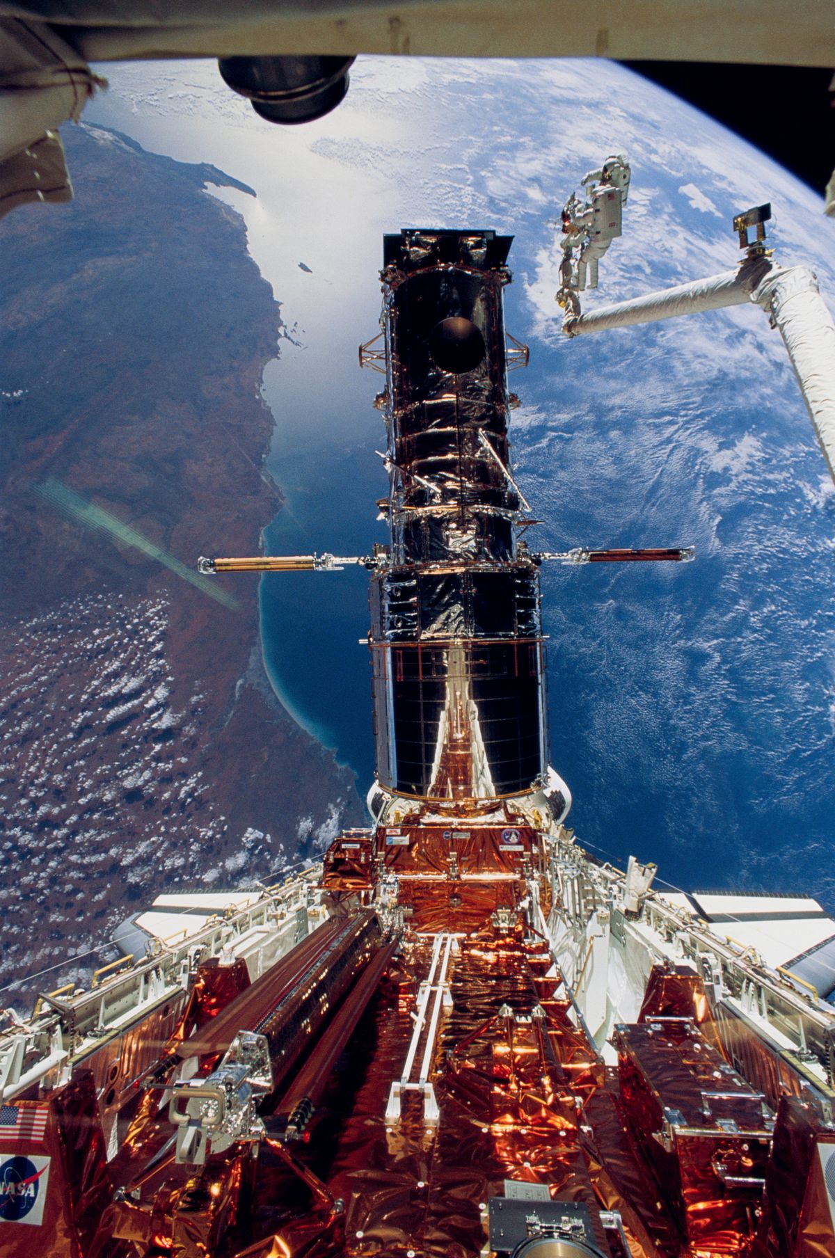A photo provided by NASA shows repairs being made to the Hubble Space Telescope by astronauts on the space shuttle Endeavour in 1993.  (NASA)