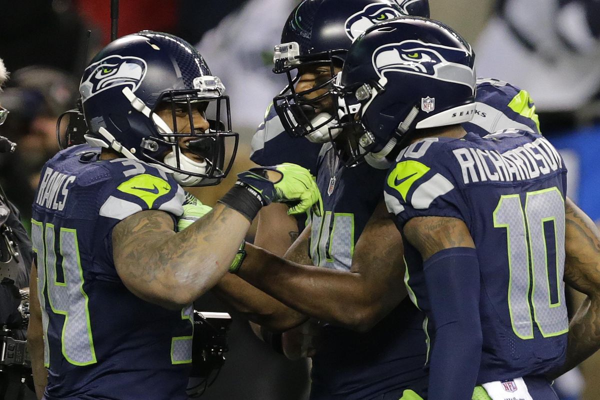 Seattle Seahawks running back Thomas Rawls, left, is greeted by wide receiver Paul Richardson, right, after Rawls scored a touchdown against the Detroit Lions in the second half of an NFL football NFC wild card playoff game, Saturday, Jan. 7, 2017, in Seattle. (Stephen Brashear / Associated Press)