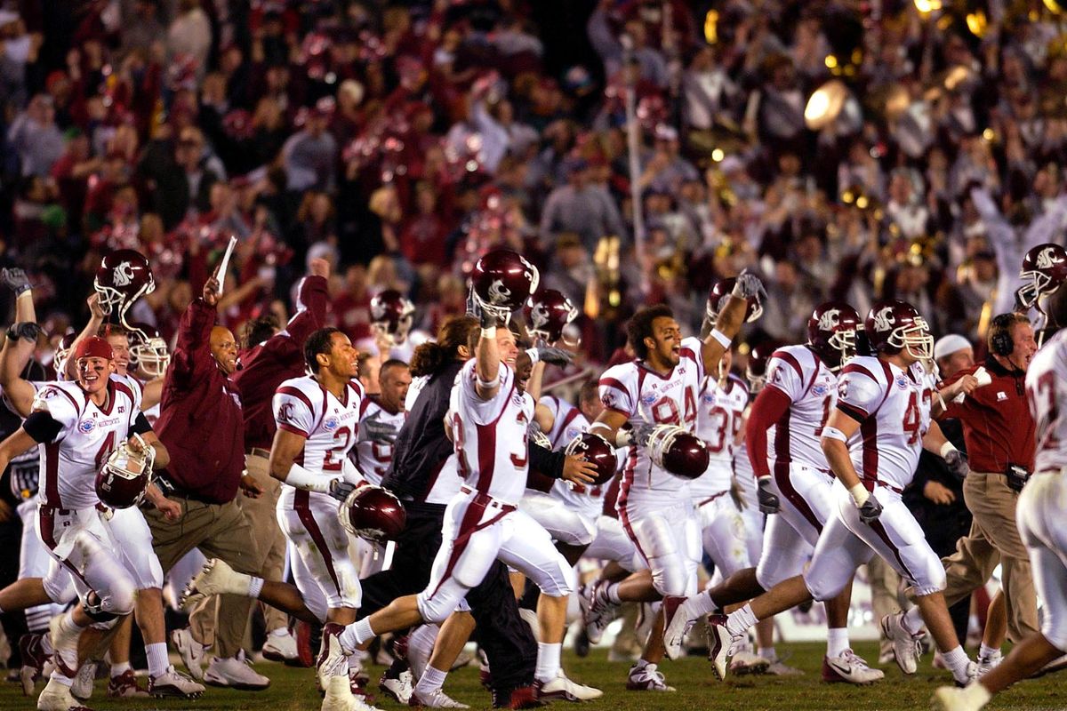 The Washington State Cougars celebrate winning the Holiday Bowl NCAA football game on Tuesday, Dec. 30, 2003 in San Diego. (Christopher Anderson / The Spokesman-Review)
