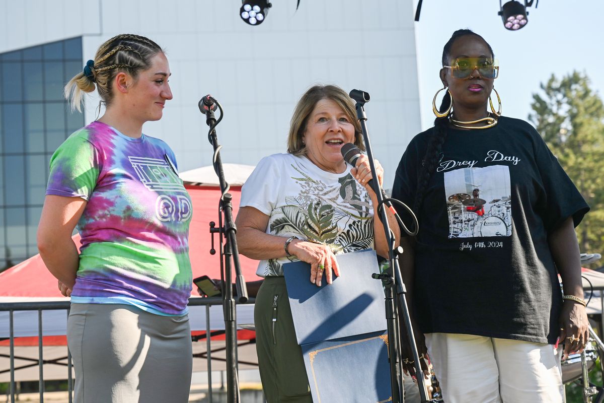 Mayor Lisa Brown proclaims Sunday, July 14, 2024 as "Drey Day" as a tribute to the late Quindrey Davis, a beloved local musician and music teacher, before a concert in Riverfront Park with Allison Davis, left, Drey