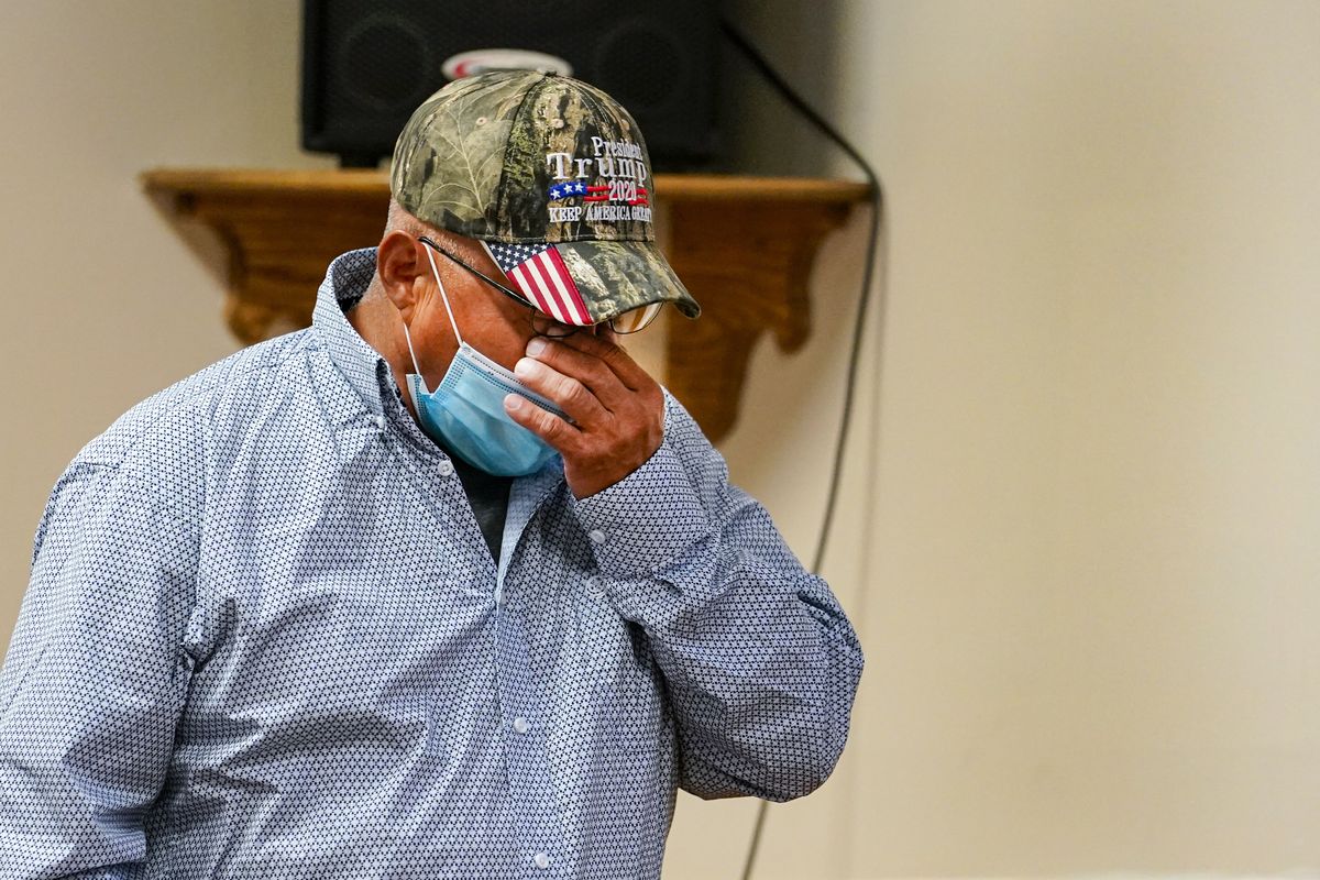 Daniel Lee, father of Tiffany Lee, wipes his face Wednesday as he leaves the podium after a statement by his attorney at the federal prison complex in Terre Haute, Ind.  (Associated Press)