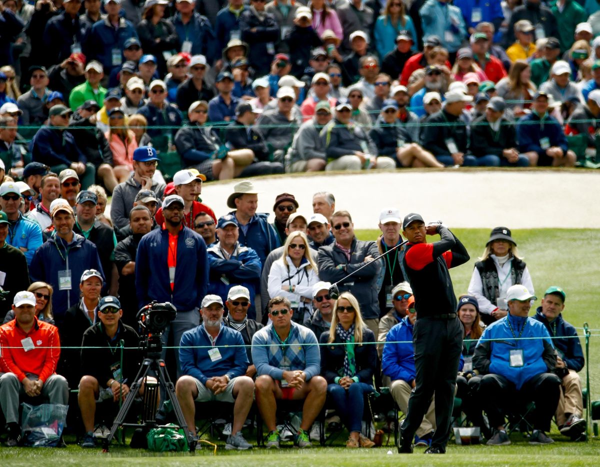 In this April 8, 2018, file photo, Tiger Woods hits a drive on the third hole during the fourth round at the Masters golf tournament in Augusta, Ga. Woods brought back the largest crowds to golf with his return from back surgery. (Charlie Riedel / Associated Press)