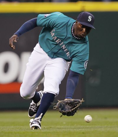 Mariners left fielder Trayvon Robinson fields a run-scoring single from Alexei Ramirez of the White Sox in the first inning of Friday night’s game at Safeco Field. (Associated Press)