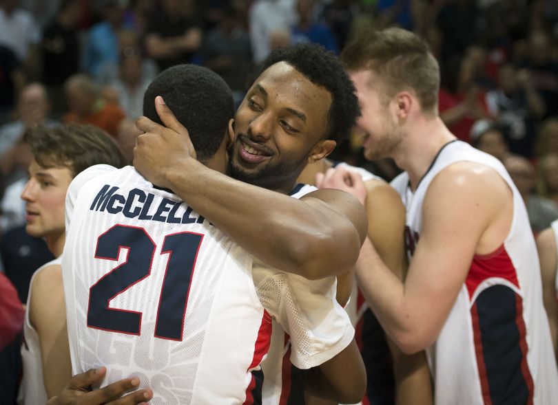 His night over – 25 points and assorted other contributions – GU guard Byron Wesley, center, hugs teammate Eric McClellan. (Colin Mulvany)