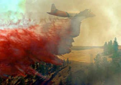 
A retardant bomber makes a run dropping its red slurry over a fire in a canyon outside Davenport, Wash.
 (Christopher Anderson/ / The Spokesman-Review)