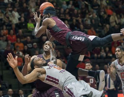 Virginia Tech’s P.J. Horne (bottom) draws a charge against Maryland-Eastern Shore’s Canaan Bartley during Friday’s game. Virginia Tech won 85-40. (DON PETERSEN / Associated Press)