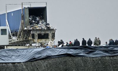 Investigators from the Port Angeles police, Pierce County Sheriff’s Dept., Tacoma police and the Washington State Patrol crime lab  search through garbage Monday at LRI landfill in Graham, Wash.  (Associated Press / The Spokesman-Review)