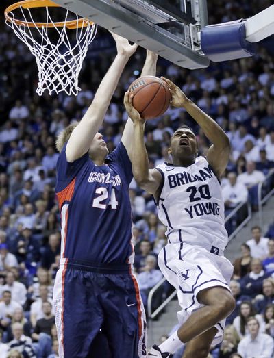 Brigham Young's Anson Winder (20) goes to the basket as Gonzaga's Przemek Karnowski (24) defends in the second half of an NCAA college basketball game Thursday in Provo, Utah. BYU won 73-65. (Associated Press)