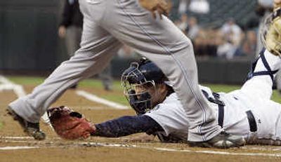 
Seattle catcher Kenji Johjima couldn't get a throw on time to tag Tampa Bay's Carlos Pena in the first inning of Thursday's game. Associated Press
 (Associated Press / The Spokesman-Review)