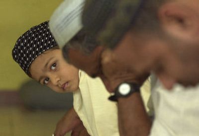 
A Sri Lankan Muslim boy looks up as others prepare for Friday Jummah prayers in a mosque in Colombo, Sri Lanka, on Friday. In a sudden surge of violence, 45 soldiers have been killed and 71 more injured in ambushes blamed on rebels. 
 (Associated Press / The Spokesman-Review)