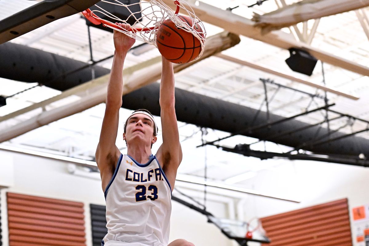 Colfax’s Adrik Jenkin dunks the ball against Liberty Bell during a State 2B regional round game on Friday at West Valley High School. (James Snook/For The Spokesman-Review)