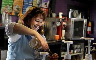 Jeannie Schell makes a coffee drink at her shop in Post Falls on Nov. 21.  (Kathy Plonka / The Spokesman-Review)