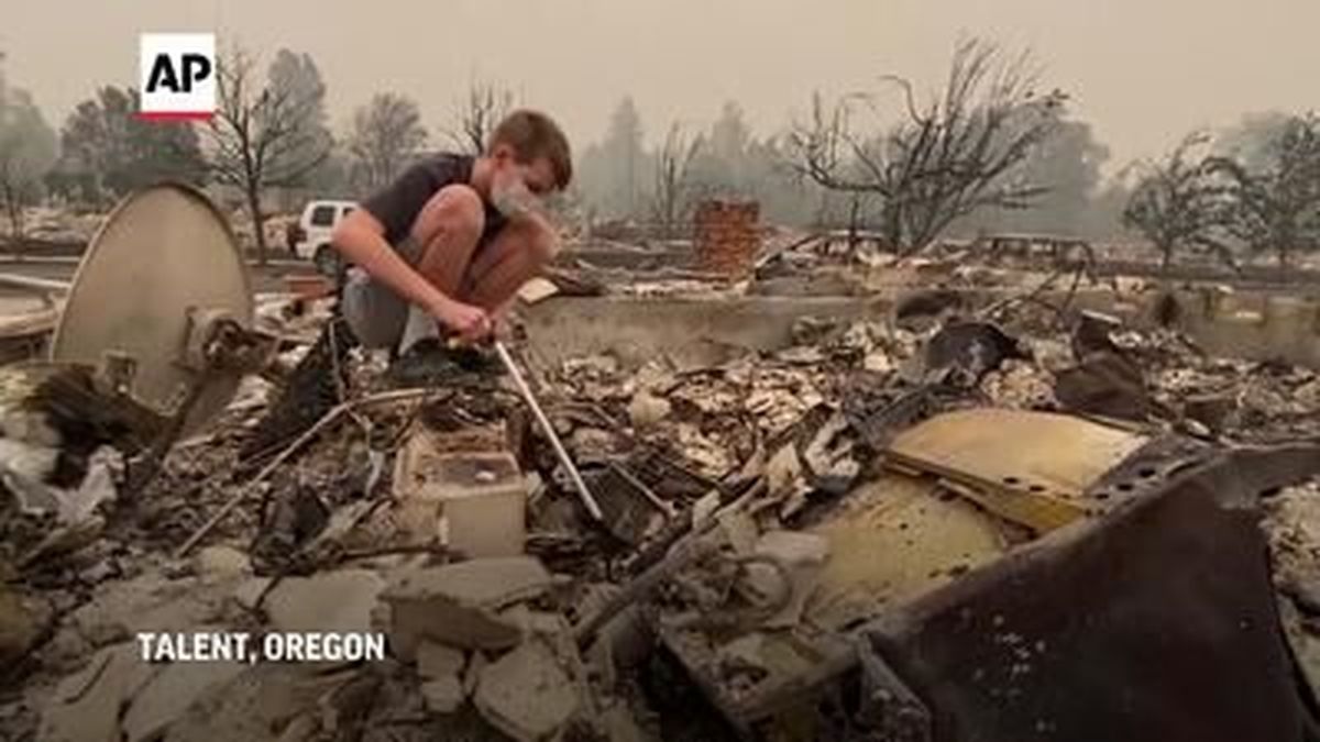 Lexi Soulios and her family snuck past roadblocks to sift through the wreckage of their Oregon home on Friday, looking for anything they could salvage. 