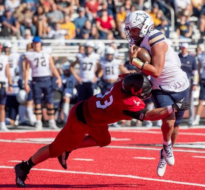 Montana State quarterback Sean Chambers tries to avoid Eastern Washington linebacker Derek Tommasini during a Big Sky Conference game Sept. 24 at Roos Field.  (Jesse Tinsley/THE SPOKESMAN-REVIEW)