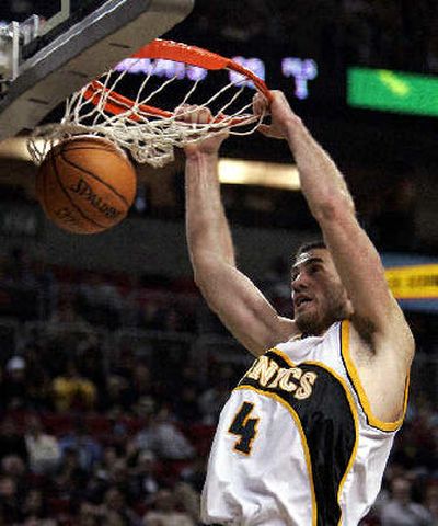 
Seattle's Nick Collison dunks in the third quarter of a win over Charlotte. 
 (Associated Press / The Spokesman-Review)