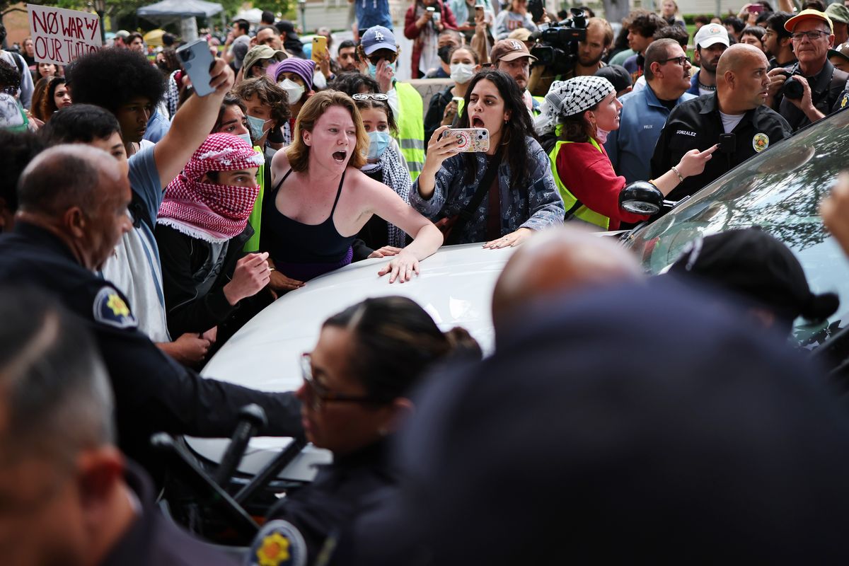Pro-Palestine demonstrators argue with USC public safety officers after officers attempted to take down an encampment in support of Gaza at the University of Southern California on Wednesday in Los Angeles.  (Mario Tama)