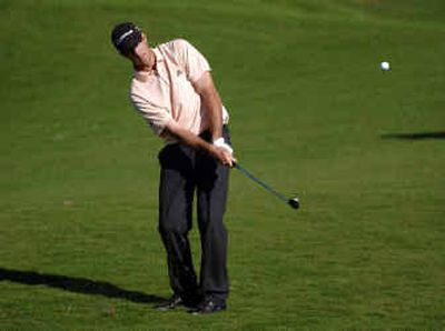 
Co-leader Geoff Ogilvy chips on the 17th green during the third round of the Honda Classic in Palm Beach Gardens, Fla.
 (Associated Press / The Spokesman-Review)