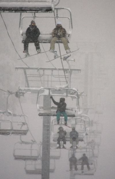 Skiers and snowboarders  ride the ski lift at Timberline Lodge in Government Camp, Ore., Tuesday.  (Associated Press)