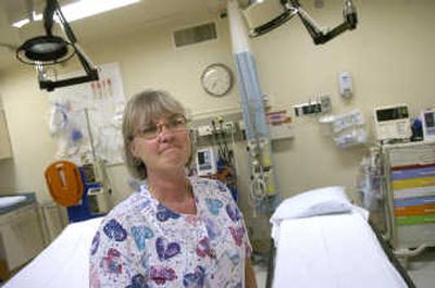 
With tears forming in her eyes while standing in the trauma room, registered nurse Lila Spotts, 56, says, 