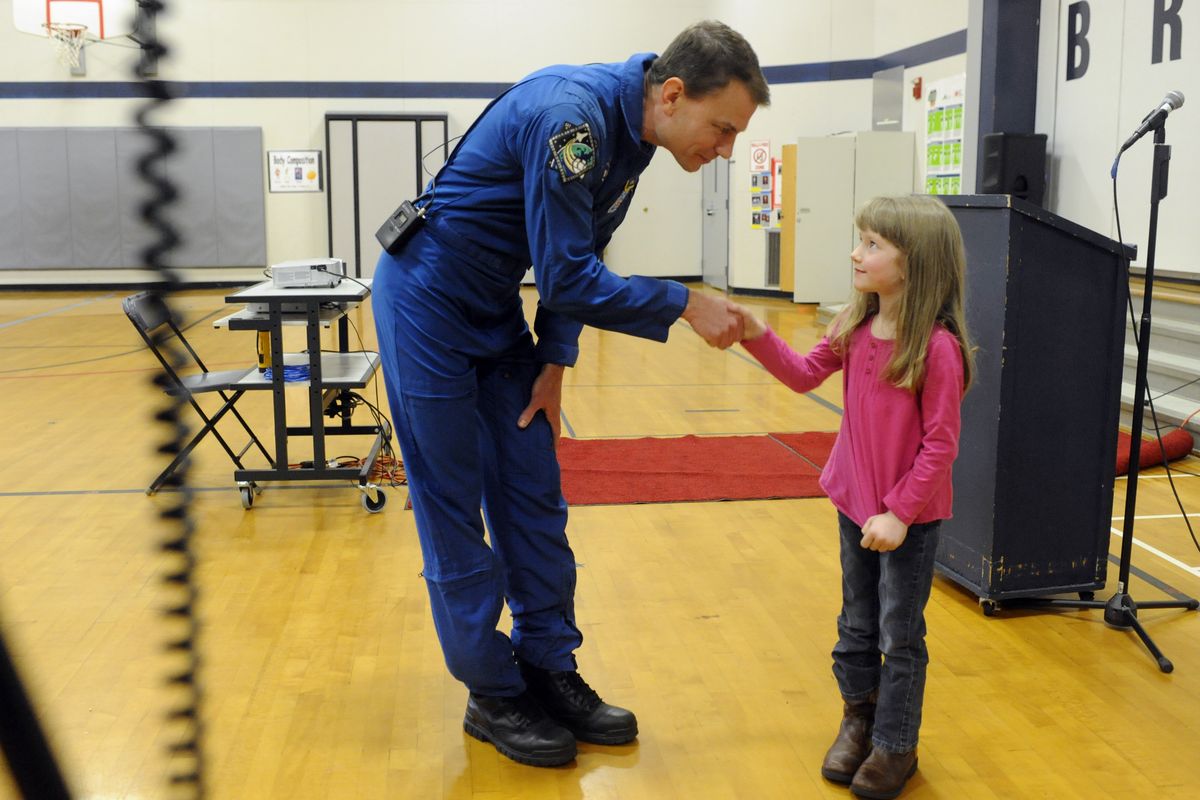 Astronaut Stanley Love shakes hands with kindergartner Mylee Ludeman during a visit to Broadway Elementary in Spokane Valley on Wednesday. Love was a misison specialist on a 2008 shuttle mission. Ludeman donated her piggy bank to help defray expenses for Love’s visit. (Jesse Tinsley)