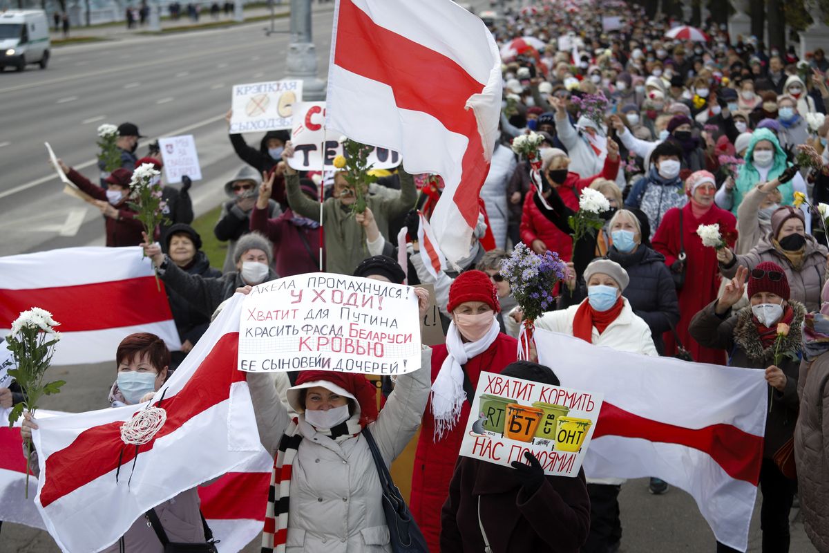 People, most of them elderly women, walk during an opposition rally in Minsk, Belarus, Monday, Oct. 19, 2020. The elderly rallied in Minsk once again on Monday to demand resignation of the country