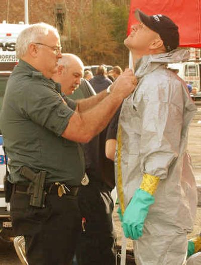 
Aiken Public Safety Capt. Ron Shelley, left, suits up Lt. Mark Farmer on Friday  in Aiken, S.C., as crews prepared to go back to the site of Thursday's train crash that killed eight people in Graniteville, S.C. 
 (Associated Press / The Spokesman-Review)