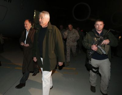 Defense Secretary Chuck Hagel, second from left, and U.S. Ambassador to Afghanistan James Cunningham, left, arrive in Kabul, Afghanistan, on Friday. (Associated Press)