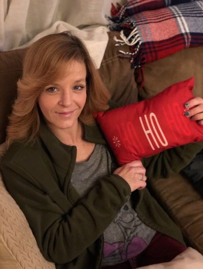 Jannell Martensen, found dead on Dec. 14, poses with a Christmas-themed pillow that reads, “Ho ho ho,” in a photo taken by her family.  (Courtesy of Shelby Martensen-Wright)